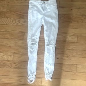 Distressed white skinny jeans